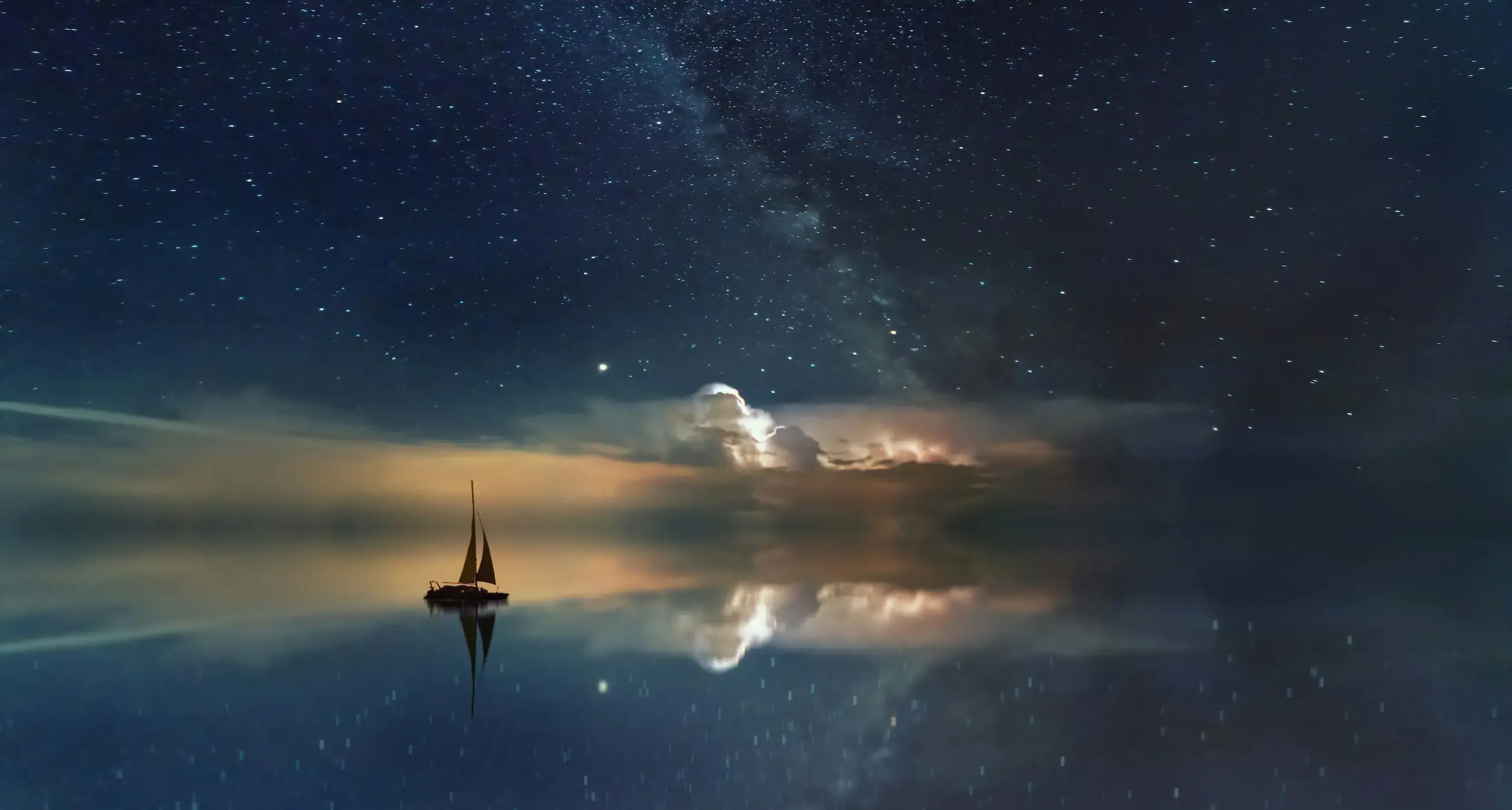 Night sky with a sail boat in the foreground