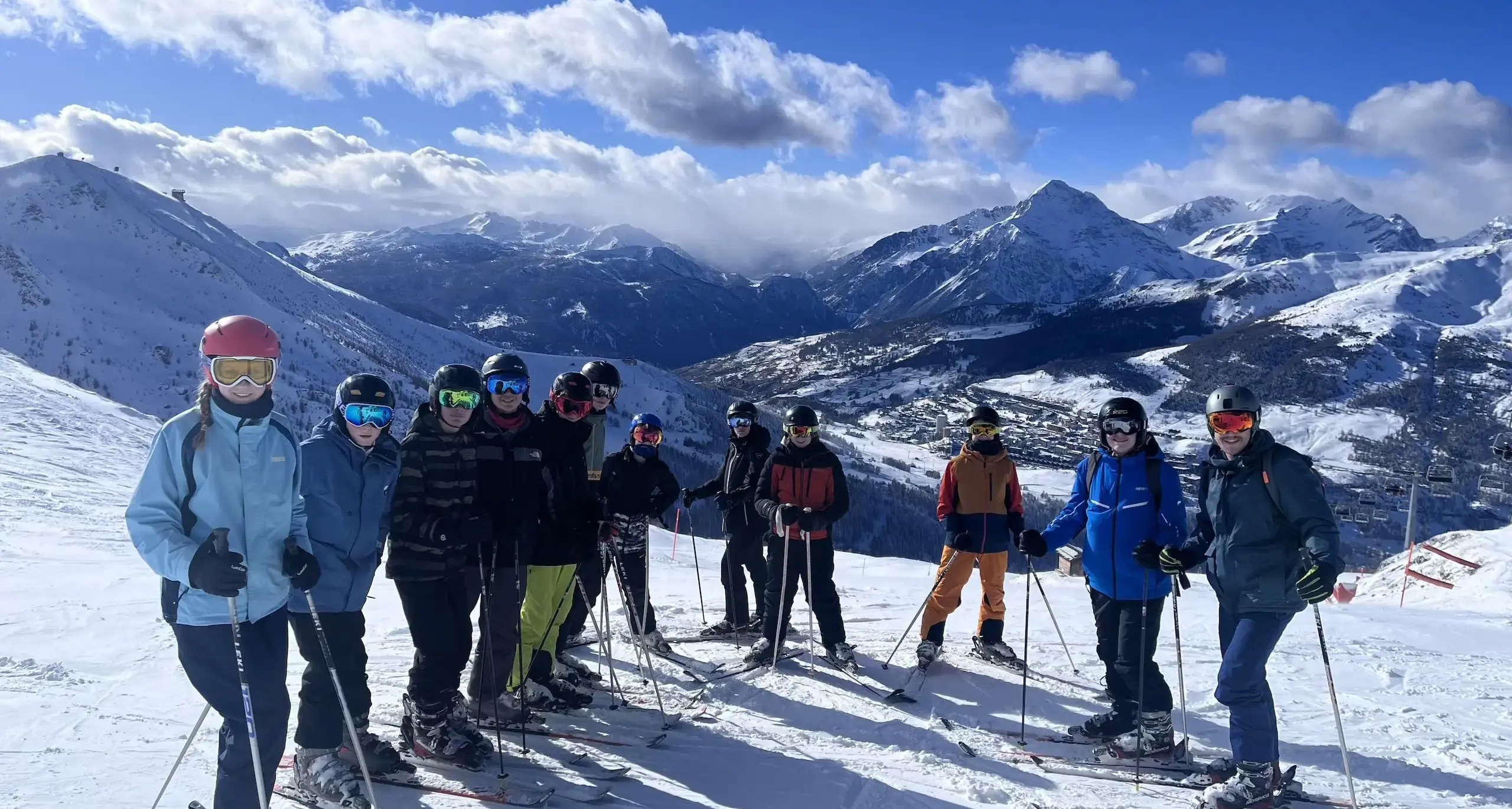 Twelve students in skiing clothing on the slopes in Italy