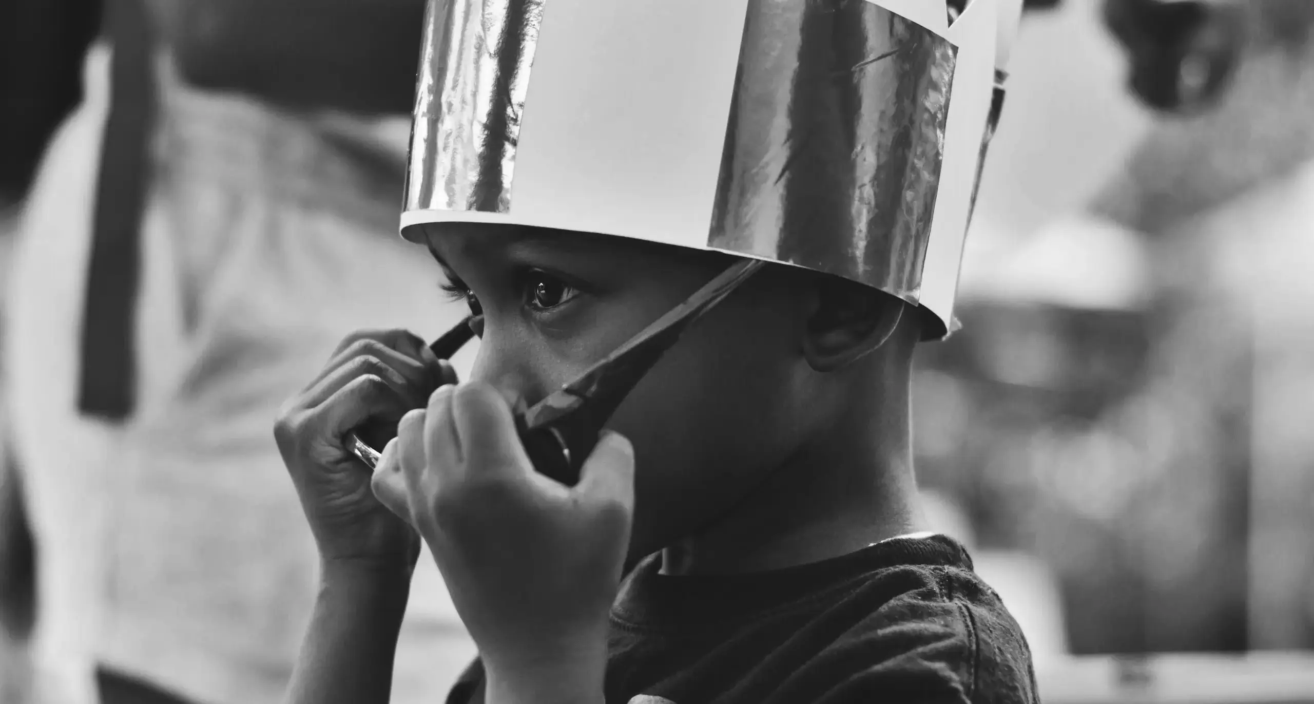 Child wearing a silver paper crown