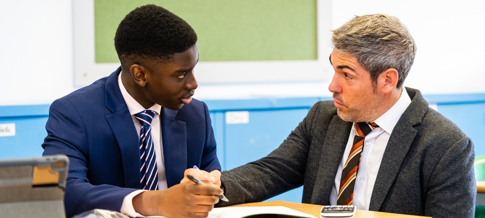 Embley Sixth Form student with teacher at desk