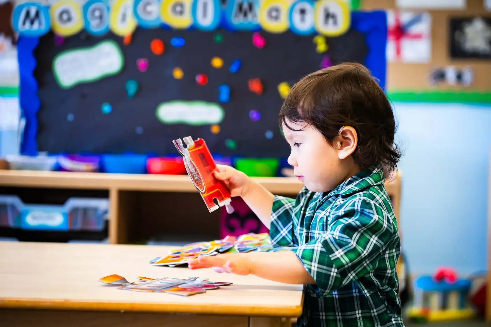 A young pre-schooler is playing at a table