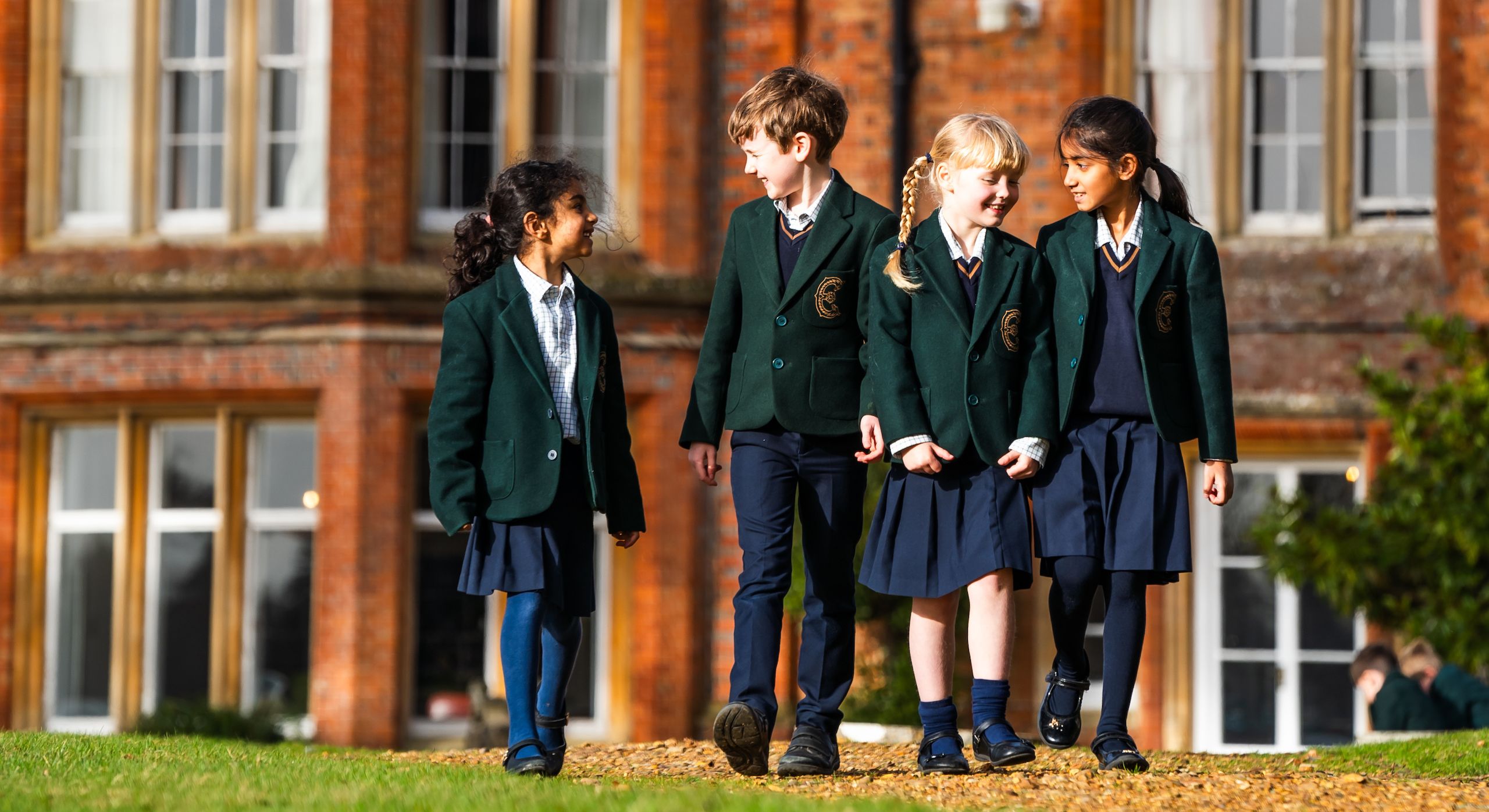 Group of Embley Prep students walking outside school building