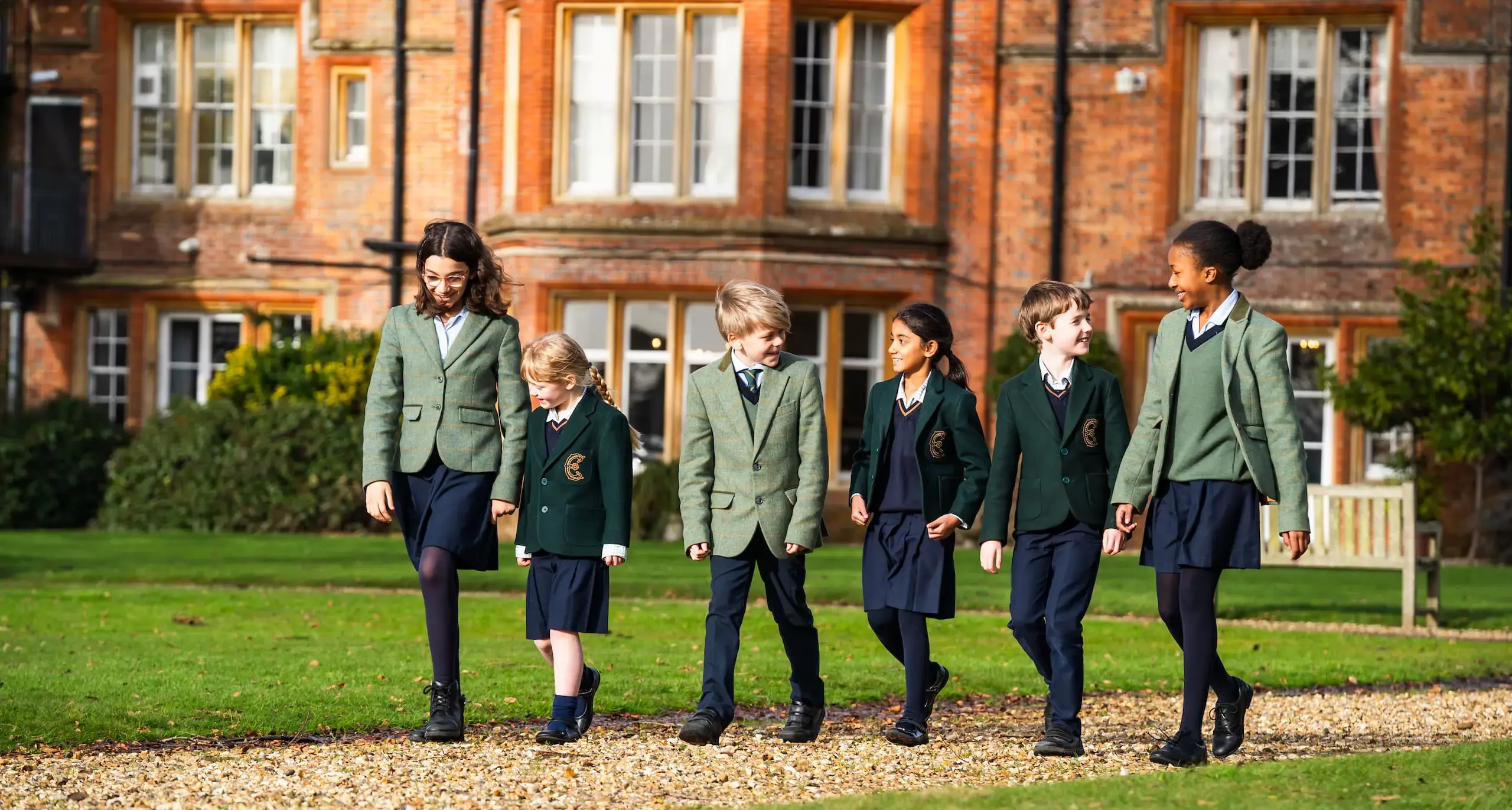 Pupils walking across Embley school grounds