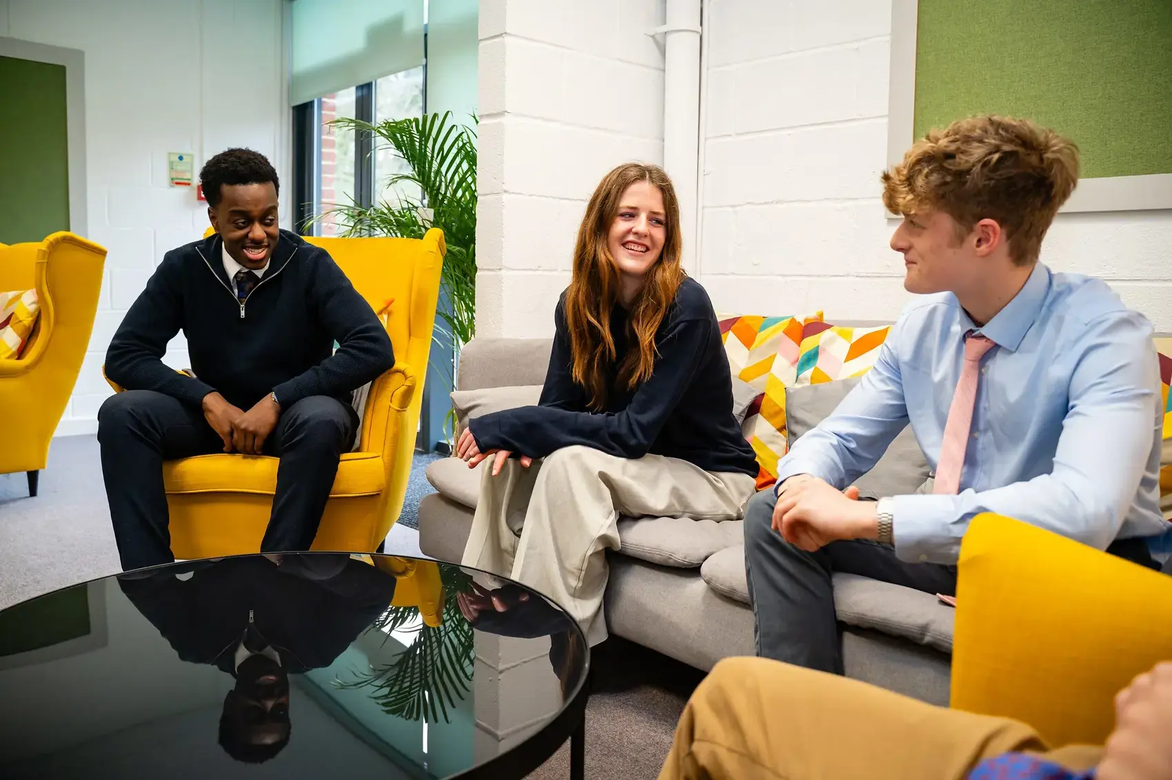 Students conversing on a couch.