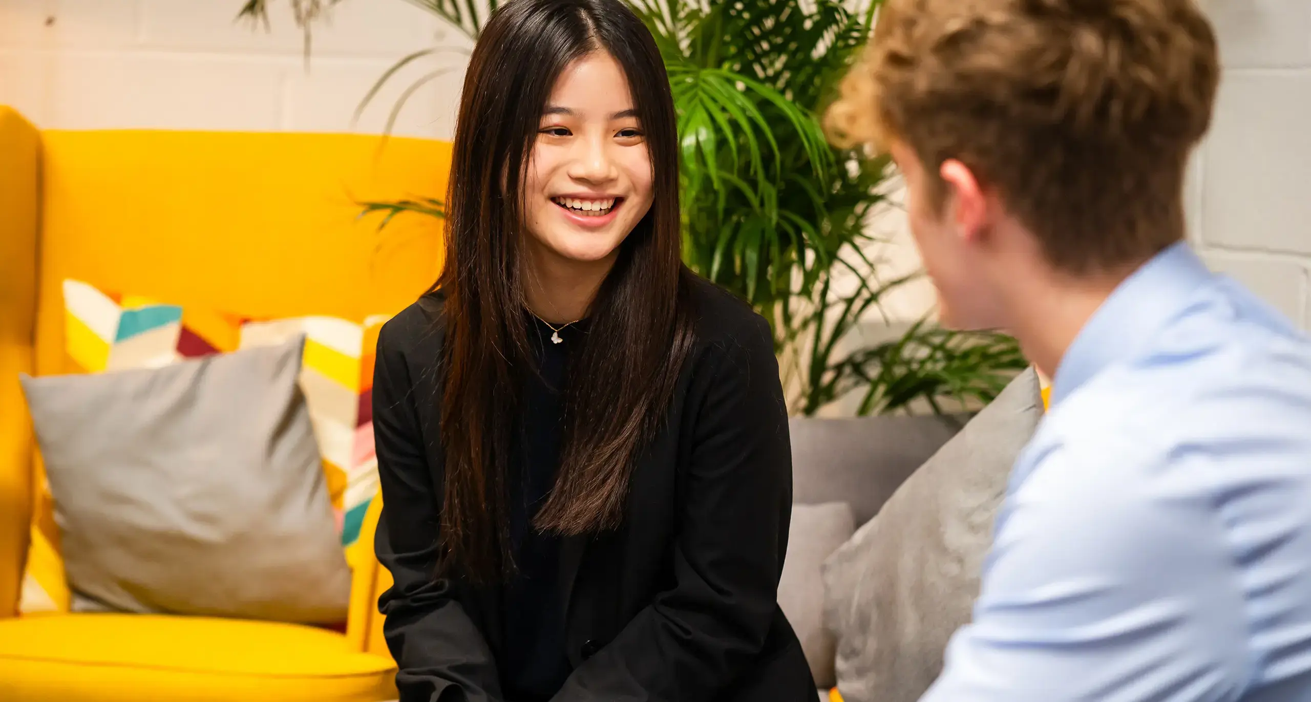 Student smiling in office.