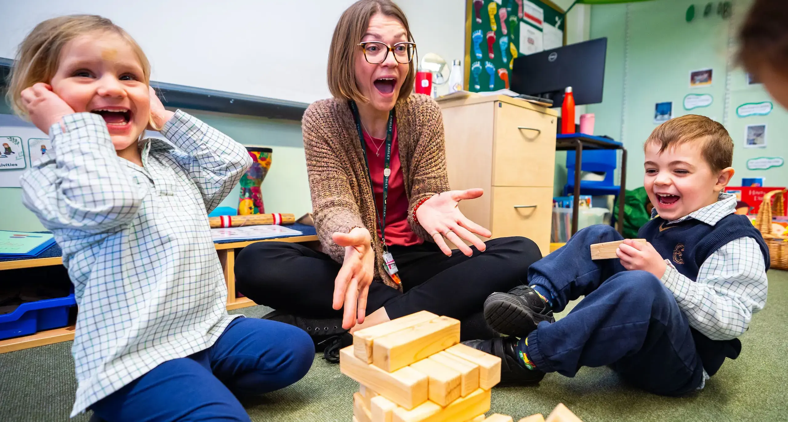 Embley nursery students laughing with teacher.