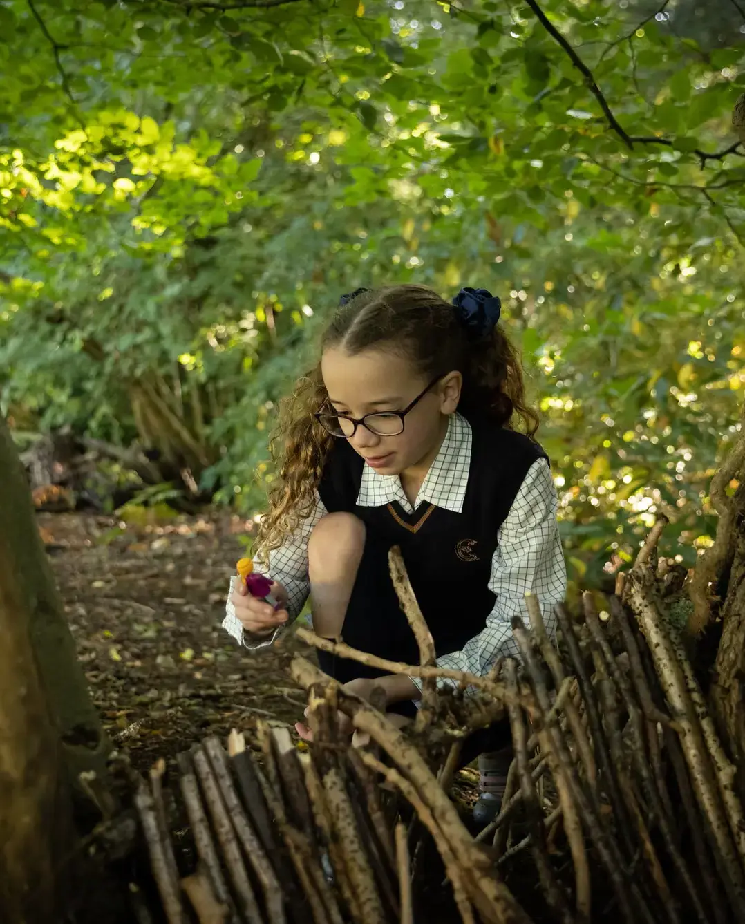 Embley prep pupil playing in forest